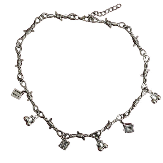 A silver-colored barbed wire choker necklace with various charms attached.