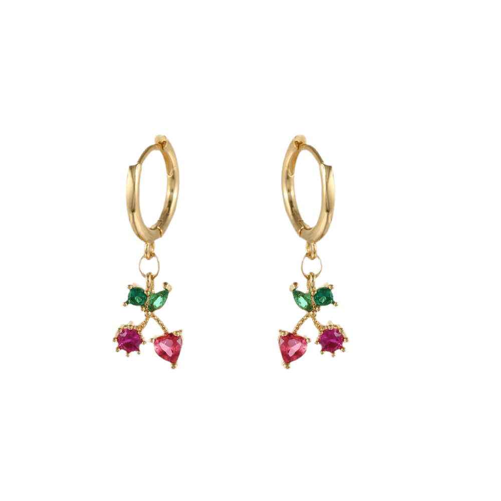 Gold hoop earrings with heart-shaped gemstones on a green background