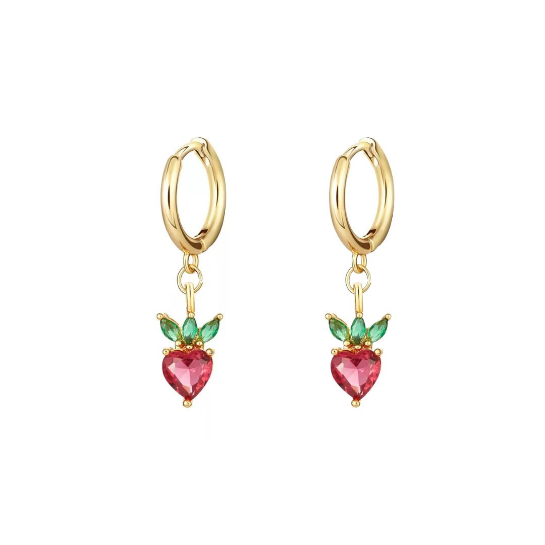Gold hoop earrings with heart-shaped pink gemstones and green leaves on a white background