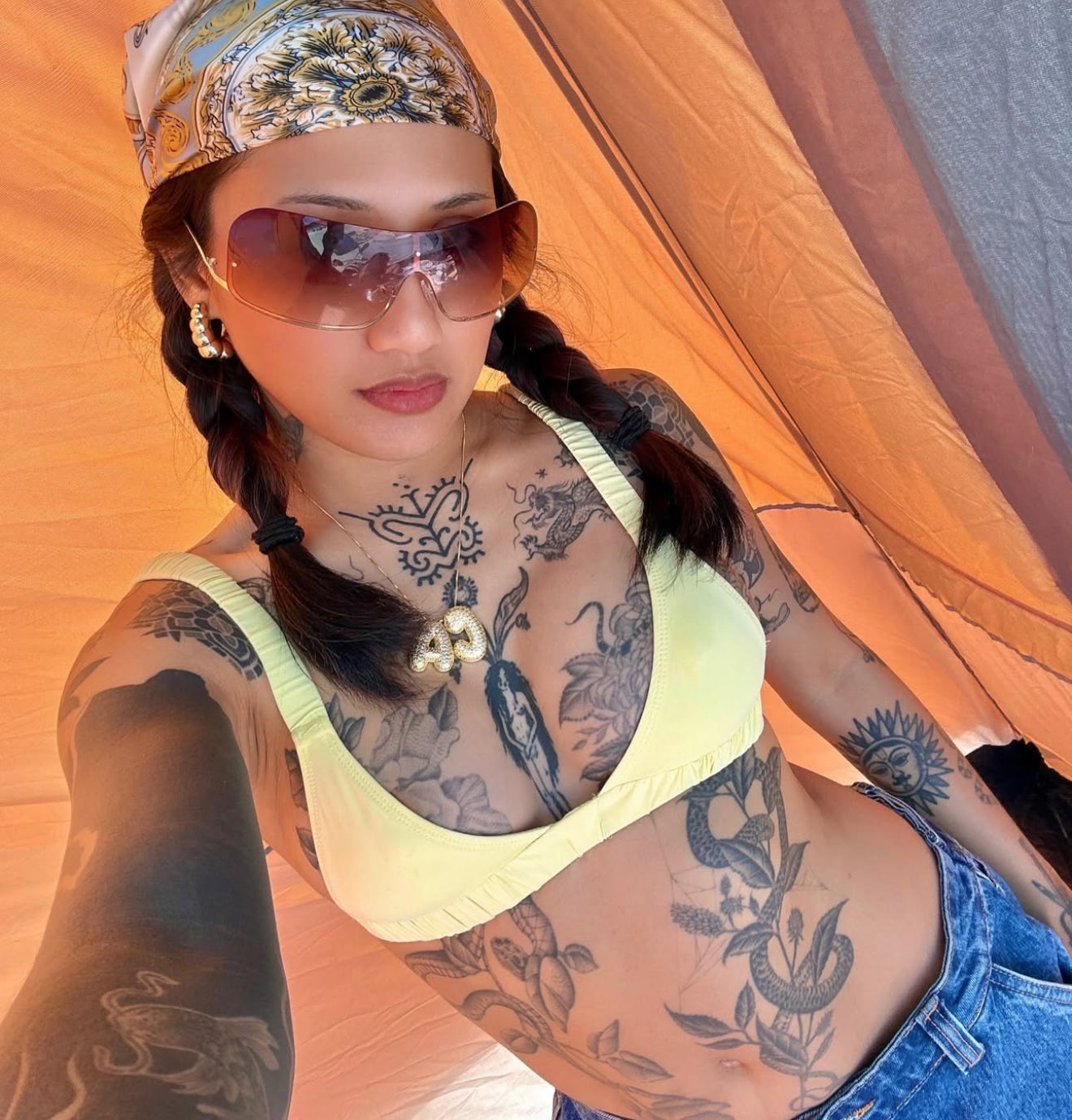 An 18K gold plated initial necklace in the shape of the letter 'B', adorned with small white stones, displayed against a white background.