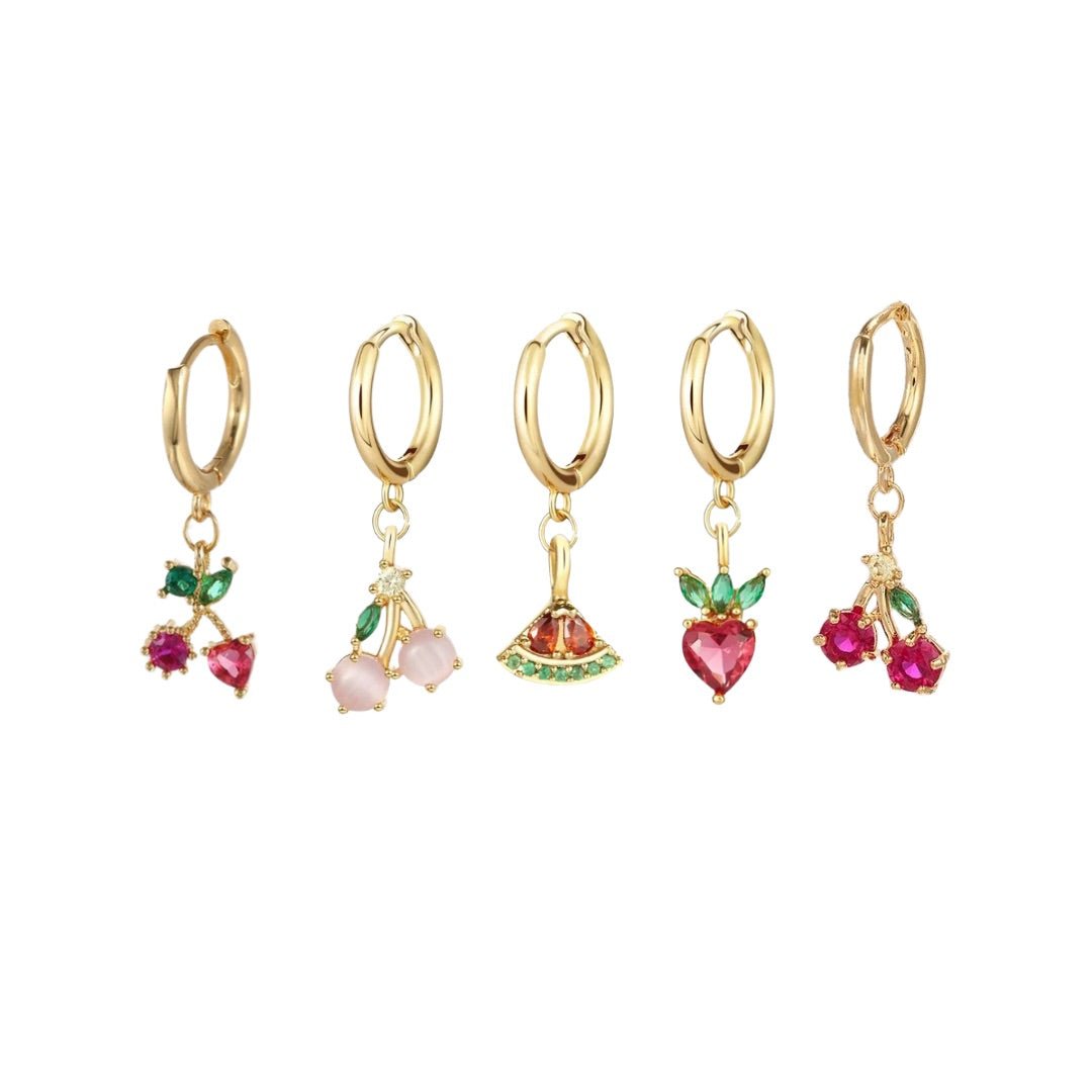 Set of five gold hoop earrings with colorful fruit charms on a white background
